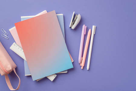 Back to school concept. Top view photo of stack of colorful notebooks pens stapler ruler clips and...