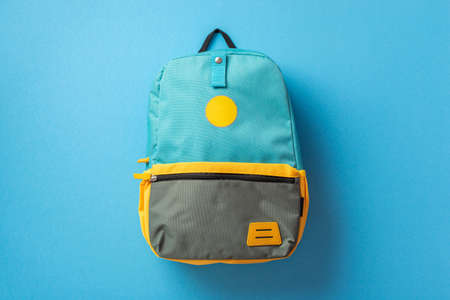 Back to school concept. Top view photo of blue backpack on isolated blue background
