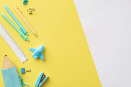 Back to school concept. Top view photo of stationery blue pencil-case plane shaped sharpener ruler...