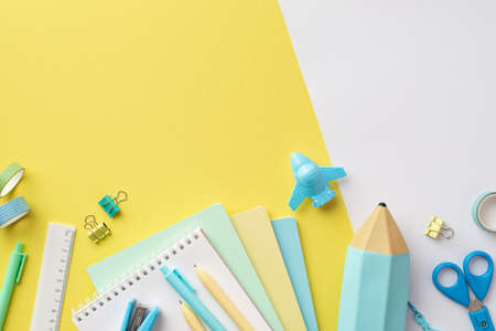 Back to school concept. Top view photo of colorful notepads plane shaped sharpener pencil-case pens...
