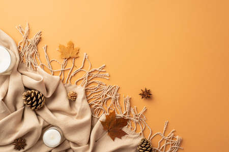 autumn aesthetic concept. Top view photo of yellow maple leaves plaid anise pine cones and candles...