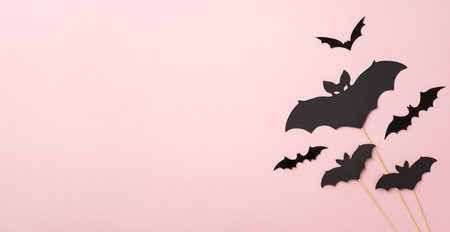Halloween party decoration concept. Top panoramic view photo of bat silhouettes on isolated pastel pink background with copyspaceの写真素材