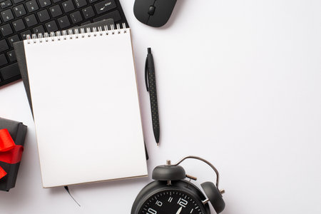 Cyber monday concept. Top view photo of reminder pen keyboard computer mouse alarm clock and gift box with red ribbon bow on isolated white background with copy spaceの写真素材