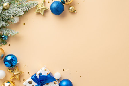 Christmas Eve concept. Top view photo of pine branches in snow star ornaments white blue gold baubles giftbox with ribbon bow and shiny confetti on isolated beige background with blank spaceの写真素材