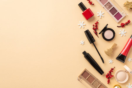 Top view photo of cosmetics red lip gloss nail polish mascara eyeshadow palettes mistletoe berries golden decorative clips and snowflakes on isolated beige background with copyspaceの写真素材