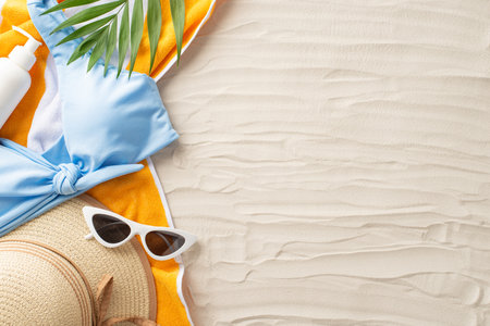Embrace summer heat. Overhead view of sunbathing must-haves: sunglasses, hat, blue woman swimsuit,...