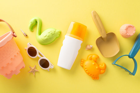 vacation with children concept. Above view photo of sunscreen spray, beach toys for sand figures and...