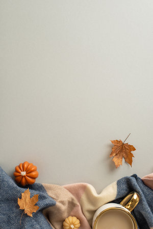 Feel the comfort of being at home in fall season with this high angle vertical view photo of warm patchy blanket with mug of hot cocoa and candles offering place for text or advert on beige isolated backgroundの写真素材