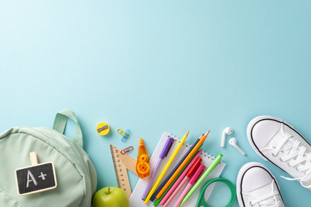 Academic journey concept. Creative overhead shot of backpack, pair of shoes, and various educational...
