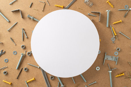 Celebrating the tireless efforts of construction workers on Labor Day. Top-down image showcasing construction components on plywood background with copyspace inside a circle available for ads or textの写真素材