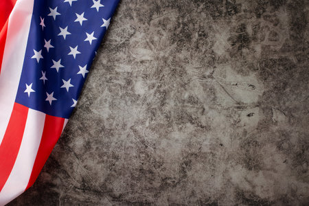 Embracing the spirit of the American public holiday: A captivating top-down photograph showcasing the American flag on a grunge textured gray concrete background. Ample copy-space for adverts or textの写真素材