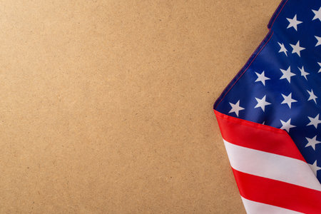 Patriotic holiday celebration: An impactful top-down photo featuring the American flag on wooden background. Ample copy-space for advertisements or text placement during the public holidayの写真素材