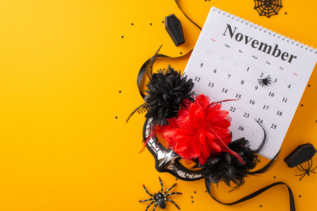 Vibrant Day of the Dead concept. Overhead shot of a traditional face mask with flowers and intricate decorations against a yellow backdrop, providing ample room for text or promotional content.の写真素材