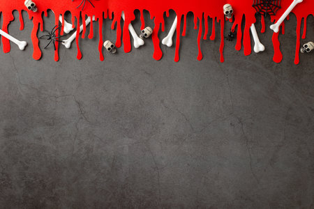 Creepy welcome scene: Top-down view featuring themed adornments - spooky spiders, spiderweb, skulls, bones, blood traces on dark grunge concrete wall background, space for advertising text or advertisingの写真素材