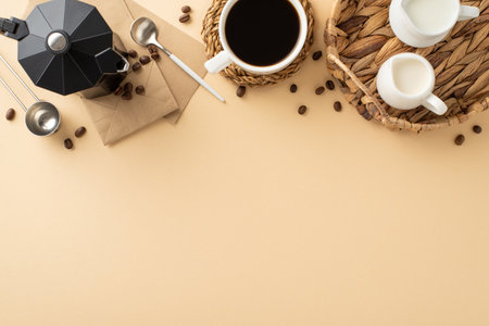 Join Coffee Day celebration. Top view of roasted coffee beans, espresso cup on placemat, cream, milk jars inside wicker tray, paper bags, spoons, kettle on soft beige, space for text or promo contentの写真素材