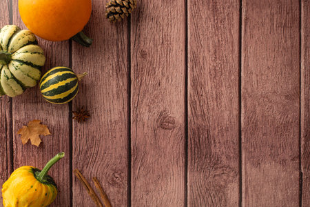 Bird's-eye perspective, Thanksgiving dinner with family embodies the essence of the fall season. Autumnal accents grace a brown wooden isolated setting, perfect for text or promotional useの写真素材