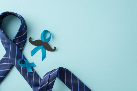 Men's Health Campaign. A top view of prostate cancer awareness symbols - blue ribbons, mustache, necktie - against a pastel blue backdrop with space for text or promotionsの写真素材