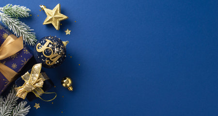 Gleaming Yuletide magic concept. Top view picture of glistening blue and gold-wrapped gifts, star toy, bright confetti, fir twigs with frost on elegant blue surface, available for your text or adの写真素材