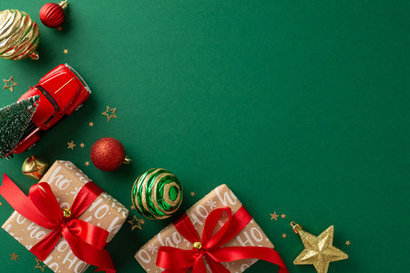 Enveloped in New Year magnificence. Above top view capturing trendy handmade gift boxes, baubles, merry ornaments, car toy transporting Christmas tree, confetti on green backdrop, with area for promoの写真素材