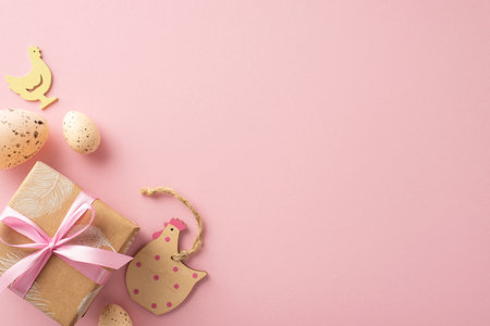Pastoral Easter theme concept. Overview of crafty gift parcel, wooden chicken accents, and quail eggs on a pink tone background, with area for textの写真素材