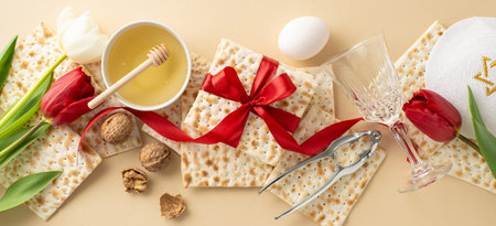 Passover chic table arrangement, top view. Consists of ribbon-wrapped matzo, goblet, walnuts, egg,...