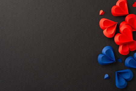 Juneteenth tribute: hearts in red and blue on black backdrop, marking freedom from slavery. Top view image invites social text or ad placementの写真素材