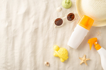 Sun safety essentials for kids at the beach. Overhead shot of sunscreen bottles, toys, straw hat,...