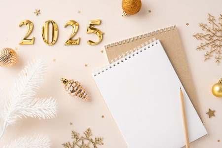 A flat lay of 2025 New Year planning with a notebook and festive decorations, evoking hope and celebrationの写真素材