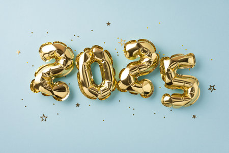 Golden foil balloons forming the numbers 2025 on a light background signify celebration and the excitement of the new year.の写真素材