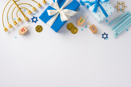 Top view of Hanukkah celebration set up with gifts, menorah, dreidels, and Star of David. Perfect for holiday greetings and Jewish festival themesの写真素材