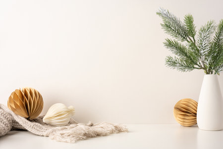 Minimalist side view Scandinavian Christmas theme featuring pine branches in a vase and natural ornaments. Cozy and elegant winter decoration with a neutral palette emphasizing simplicity and warmthの写真素材