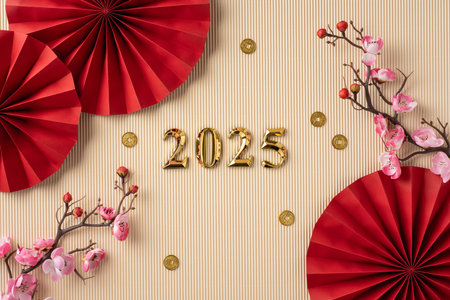 Festive Chinese new year design featuring red paper fans, cherry blossoms, and gold coins surrounding the year 2025の写真素材