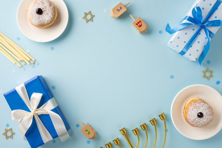 A vibrant Hanukkah scene featuring traditional dreidels, a menorah, and wrapped gifts. The blue theme adds a festive touch to this joyful celebration setupの写真素材