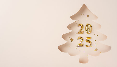 A stylish paper cutout of a Christmas tree revealing golden 2025 numbers surrounded by decorative stars. The design captures the festive and elegant spirit of the new year celebrationの写真素材