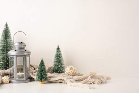 A side view warm, minimalist Scandinavian christmas setting features a candle lantern, miniature trees, and rustic decorations creating a cozy atmosphereの写真素材