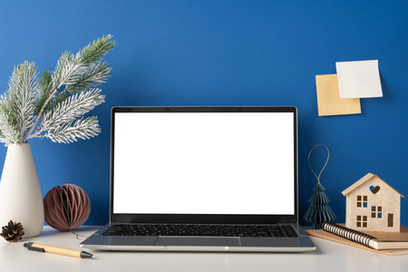 Elegant side view minimalist workspace featuring a laptop, Scandinavian decor, and winter accents. Perfect for modern and stylish office settingsの写真素材