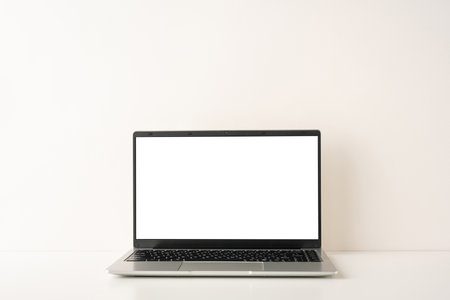 A side view of a simple and elegant laptop on a minimalist desk, reflecting a Scandinavian design style. Perfect for modern workplaces and creative spaces, highlighting simplicity and functionalityの写真素材