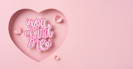 A charming pink heart-shaped cutout featuring the words 'you and me' symbolizes love and romance, perfect for Valentine's Day celebrationsの写真素材