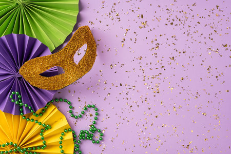 Festive Mardi Gras composition featuring glittery masks, colorful beads, decorative papers, and confetti embellishments, radiating celebration and carnival atmosphereの写真素材