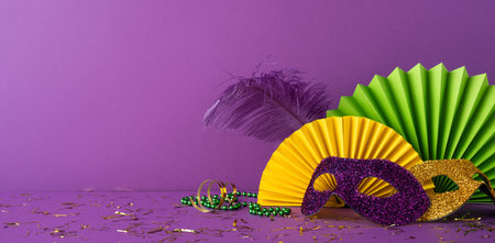 Festive Mardi Gras side view masks in purple and gold, with colorful fans and matching decorationsの写真素材