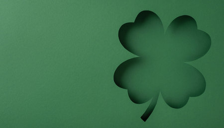 Clover-shaped cutout on a green background, perfect for St. Patrick's Day themes or designsの写真素材