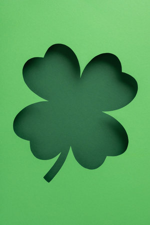 A vertical paper cutout of a shamrock leaf representing Irish culture and festive celebrationsの写真素材