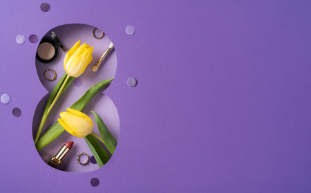 Yellow tulips and cosmetics on a purple background symbolize beauty and celebration. The floral arrangement and items invoke themes of femininity, elegance, and appreciation for womenの写真素材