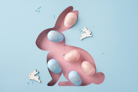 Easter themed design featuring a bunny-shaped cutout decorated with pastel Easter eggs and confetti, perfect for festive or springtime celebration visualsの写真素材