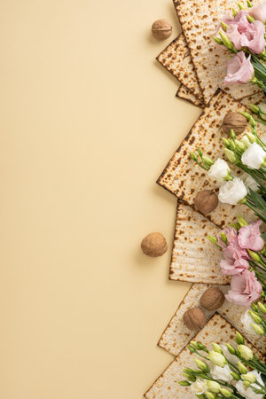 Flat lay of Passover matzah, floral vertical setup, and walnuts on a warm beige backdropの写真素材