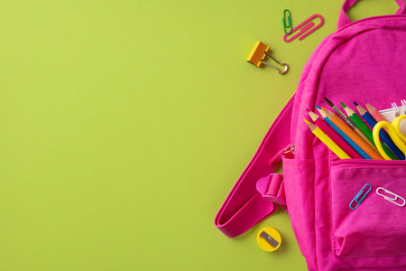 Colorful school supplies including a pink backpack, pencils, and paper clips on bright surface