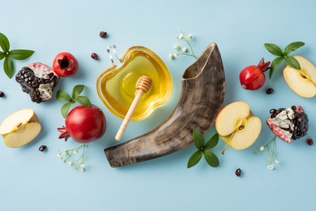 Rosh Hashanah vertical still life arrangement with honey, apples, pomegranates, and shofar connected with Jewish New Year celebrationの写真素材