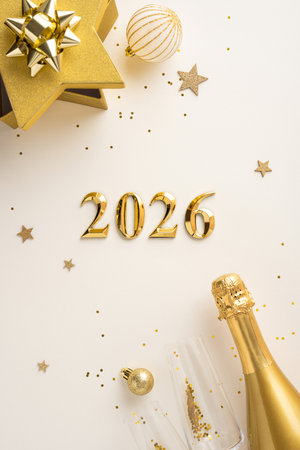 Festive vertical composition celebrating the new year 2026 with gold decorations and champagne.