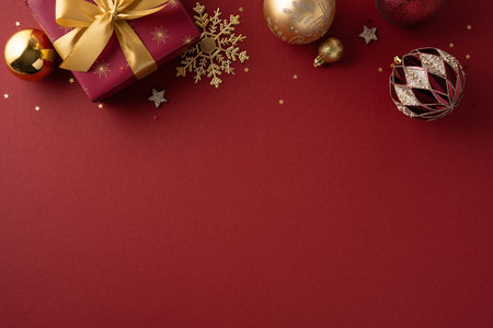 A red festive background with wrapped gifts, gold ribbon, snowflakes and ornaments, capturing Christmas and New Year celebration mood, warmth, joy and family moments with seasonal charmの写真素材