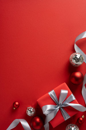 Vertical arrangement features red gifts with silver ribbons, baubles, and festive decor ready for Christmas and New Year greetingの写真素材